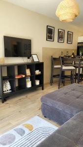 a living room with a flat screen tv and a couch at Sunrise Apartment in Schladming