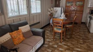 a living room with a couch and a table at Marychris in Saint-Loubès