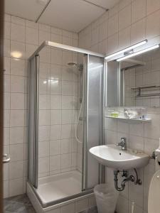 a bathroom with a shower and a sink at Hotel Garni Vindobona in Pörtschach am Wörthersee +54 photos