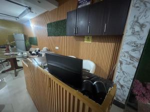 a kitchen with a counter with a laptop on it at City Palace in Zirakpur