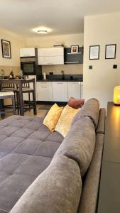 a living room with a couch and a kitchen at Sunrise Apartment in Schladming