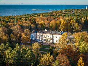 an aerial view of a building on a hill next to the ocean at To Be Apartament Palanga in Palanga