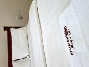 a white towel with the word quarantine written on it at Kilimanjaro Magic MJ Branch in Old Moshi +8 photos