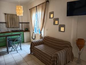 a bedroom with a bed and a desk in a room at Sunshine in Maltezana