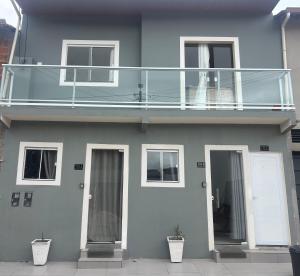 a blue house with a balcony on top of it at Casa siles in Mucugê