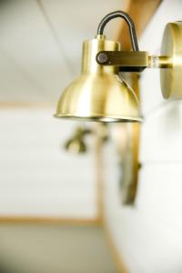 a close up of a brass light on a wall at Saimaa Experience - laivamajoitus in Puumala