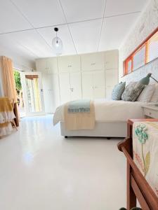 a bedroom with a large bed in a room at Rijke Rust, Living the Lagoon Life in Langebaan