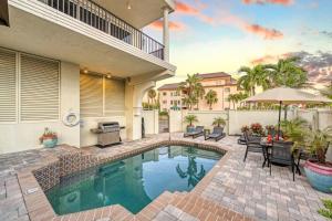 a swimming pool in front of a house at Admirals Watch - 673 in Siesta Key