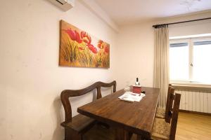a dining room table and chairs with a painting on the wall at Wine Apartments Florence Malvasia in Florence +13 photos