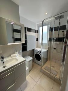 a bathroom with a shower and a sink and a washing machine at Bella Stay in Cannes +14 photos