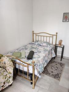 a bedroom with a bed and a chair and a table at Casa Bruzio B&B in San Giorgio di Piano