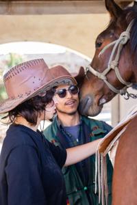 a man and a woman standing next to a horse at Horse & Bed Hostel in Puebla