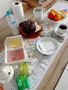 a table with a table cloth with food on it at Hostel Uziel in Timbó