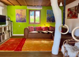 a living room with green walls and a couch at Haus im Rübental in Bad Dürkheim