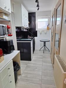 a kitchen with a table in the middle of it at Noclegi 2 pokoje in Szczecinek