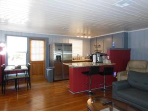 a living room with a kitchen with a counter and a kitchen at Indian Beach Cottage in Sarasota