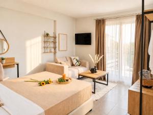 a living room with a couch and a table at AISTHISIS Suites in Ierissos