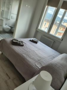 a bedroom with a bed and a large window at Attico 101 in Pistoia