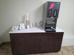 a counter with a coffee machine on top of it at Red Roof Inn Green Brook - Somerset in Green Brook