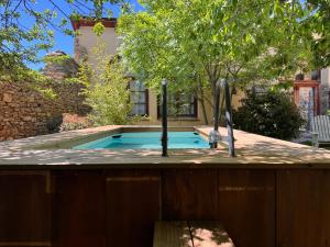 a swimming pool with two faucets in a backyard at Cal David Estamariu in Estamariu