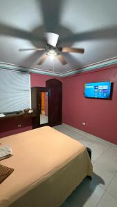 a bedroom with a bed and a ceiling fan at Villa Simon Guest house in Les Cayes