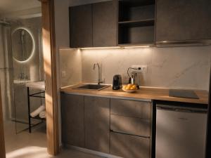 a small kitchen with a sink and a shower at AISTHISIS Suites in Ierissos +86 photos