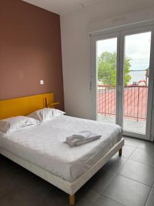 a bedroom with a bed and a view of the ocean at Le Moutchico in Lacanau