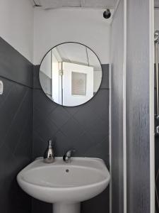 a bathroom with a sink and a mirror at Casa de Férias Palmeira in Faro +71 photos