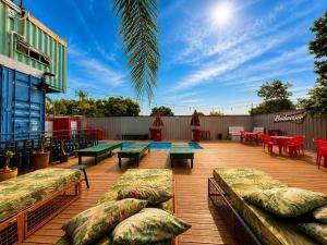 a patio with couches and tables and a pool at Tetris in Foz do Iguaçu