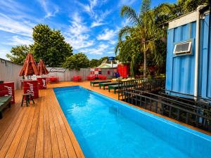a swimming pool on a deck next to a house at Tetris in Foz do Iguaçu