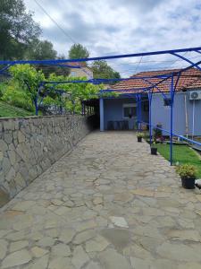 a stone patio in front of a house at Tommy's Guest House in Konitsa