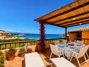 a table on a patio with a view of the ocean at Sea View Three-Bedroom House 50m from the Beach in Baja Sardinia