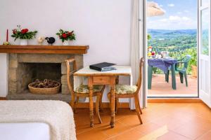 a living room with a table and a fireplace at La Vignaredda - Residenza di Charme in Aggius +41 photos