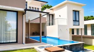 a swimming pool in the backyard of a house at SleepRest @ Nagoya Valley in Nagoya