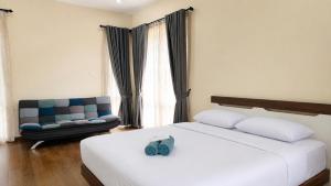 a hotel room with a bed and a chair at SleepRest @ Nagoya Valley in Nagoya +39 photos