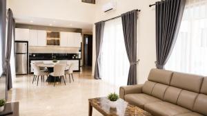 a living room with a couch and a table at SleepRest @ Nagoya Valley in Nagoya