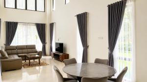 a living room with a table and a couch at SleepRest @ Nagoya Valley in Nagoya
