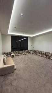 a large empty room with a couch and a stage at شاليهات الحدبان - Al Hadban Chalets in Ash Shafa +55 photos