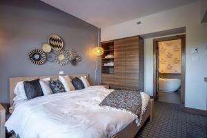 a bedroom with a large bed and a bathroom at Suite with mountains view & Resort access in Lac-Superieur +43 photos