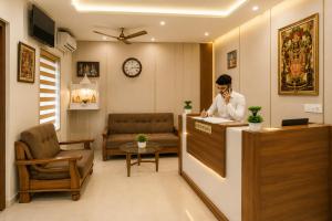 a man talking on a phone in a waiting room at Shri Raghav Palace Hotel Ayodhya in Ayodhya