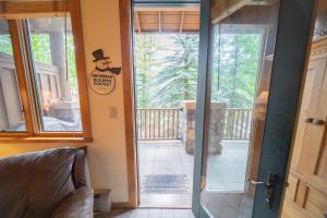 a door to a porch with a cowboy sign on it at Arapahoe Lodge 8105 by SummitCove Lodging in Colorado in Keystone