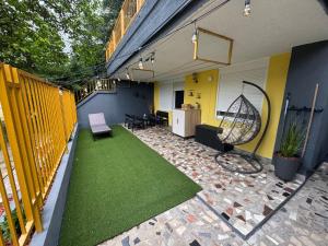 a patio with green grass on the side of a house at Neretva Paradise Mostar in Mostar