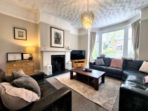 a living room with a couch and a table at Royal Victoria House in Scarborough