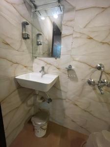 a bathroom with a sink and a mirror at Hotel Bkc Palace Kurla in Mumbai