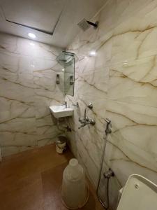 a bathroom with a toilet and a sink at Hotel Bkc Palace Kurla in Mumbai