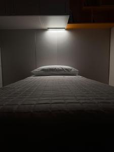 a bedroom with a bed with a light above it at The Fruit House in Cascina