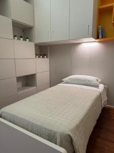 a bedroom with a bed with white cabinets at The Fruit House in Cascina