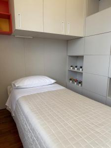 a bedroom with a bed with white cabinets at The Fruit House in Cascina +23 photos