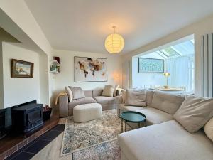 a living room with a couch and a tv at Cottage 493 - Clifden in Clifden