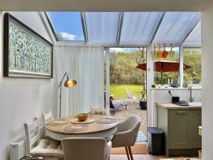 a kitchen and dining room with a table and chairs at Cottage 493 - Clifden in Clifden